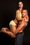 Fitness couple poses in studio - fit man and woman