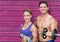 fitness couple with wights with pink wood background