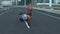 Fitness, crossfit and professional woman athlete running with parachute resistance training in urban city street. Sports