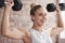 Fitness, dumbbell weights and woman training for a weightlifting exercise in the gym or studio. Sports, health and