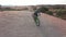 Fitness, dunes and man cycling in desert on an adventure trail training for race or competition. Sports, bicycle and