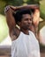 Fitness, exercise and black man stretching arms in nature to start training workout outdoors. Sports, thinking and male