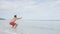 Fitness exercise man doing air squat on beach