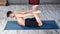 Fitness flexible male enjoying pilates making stretching lying on mat high angle