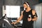 Fitness-focused man holding water bottle while operating treadmill at gym