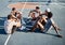 Fitness, friends and relax on basketball court floor with basketball players group bond, resting and talking on a break