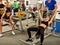 Fitness friends workout gym. Woman working on bench press.