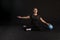 Fitness girl with Aqua ball, doing exercises. Engaged in sports on a black background Happy with a good look