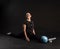 Fitness girl with Aqua ball, doing exercises. Going in for sports on a black background looking at the camera