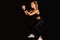 Fitness Girl Doing Deep Squat Exercise Over Black Studio Background