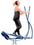 Fitness girl doing exercises on elliptical cross trainer exercise machine