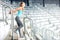 Fitness girl doing fitness exercises and working out on stadium stairs. Jogger on morning training, healthy lifestyle concept