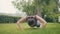 Fitness girl doing push ups exercises during outdoor training in summer park