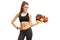 Fitness girl holding a plate of vegetables and fruit