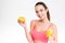 Fitness girl with orange half and glass of juice