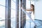 Fitness girl practicing twine. .Flexible woman in the gymnastics room stretches by the panoramic window.