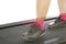 Fitness girl running on treadmill. Woman with muscular legs on w