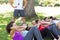 Fitness group doing sit ups in park with coach