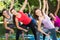 Fitness group doing yoga in park