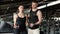 Fitness Guidance Male Personal Trainer Assisting Woman in Gym Session