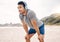 Fitness, headphones and portrait of man on beach running for race, marathon or competition training. Sports, workout and