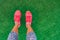 Fitness and health concept. Top view of running shoes woman standing on grass pov selfie of feet during exercise run