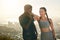 Fitness, hiking and interracial couple excited about training goal, motivation and support in nature with city. Workout