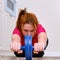 Fitness at home, training to strengthen the abdominal press during the coronavirus epidemic. A young woman sports in the kitchen