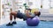 Fitness, home workout and a black man lifting weights on an exercise ball for strong muscles in the living room. Gym