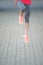 fitness jogger legs in jump at park. Woman fitness jogging workout wellness concept.