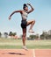 Fitness, jump or black woman runner on a race track in training, cardio workout or sports exercise in summer. Jumping