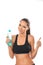 Fitness lady holding a bottle of water and giving thumbs up