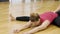 Fitness lady is stretching body with trainer in sports club.