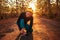 Fitness lifestyle portrait of young attractive Asian runner woman suffering sport injury during jogging workout on sunset road