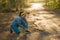 Fitness lifestyle portrait of young attractive Asian runner woman suffering sport injury during jogging workout on sunset road