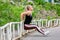 Fitness lifestyle. Young woman doing push ups from the pillar. Sporty young blonde girl on a sunny day at the stadium. Healthy