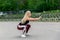 Fitness lifestyle. Young woman doing squats. Workout at the stadium. Healthy life concept. Horizontal photo