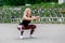 Fitness lifestyle. Young woman doing squats. Workout at the stadium. Healthy life concept. Horizontal photo