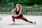 Fitness lifestyle. Young woman warming up before training doing exercises to stretch her muscles and joints. Workout at the
