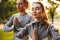 Fitness loving couple friends in park make meditate exercises.