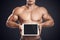 Fitness male holding horizontally digital tablet with blank scre