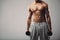 Fitness male model with dumbbells on grey background