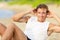 Fitness man doing crunches sit-ups on beach