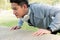 Fitness man doing strength training exercise pushup at outdoor