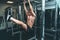 Fitness man hanging on horizontal bar performing legs raises, in the gym