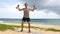 Fitness man lifting dumbbells on beach doing Shoulder Dumbbell Side Raise