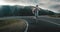 Fitness man running on highway around the mountains.