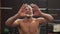 Fitness man shows heart gesture with calloused handsafter hard workout in gym