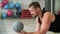 Fitness man throwing ball while pushing up on floor at crossfit training. Athlete man training push up exercise with