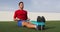 Fitness man training arms with resistance bands doing seated row exercise